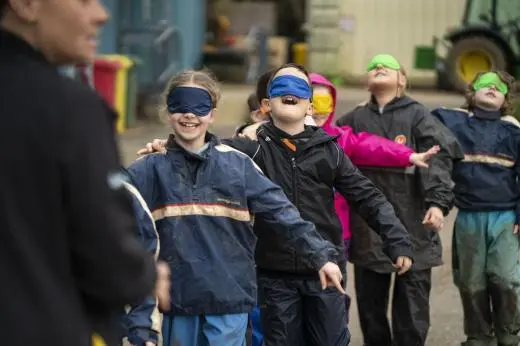 children learning blindfolded trust exercises